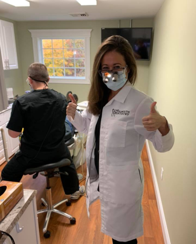 Doctor Chadbourne giving thumbs up in dental office