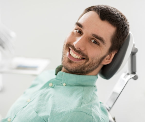 Smiling man leaning back in dental chair