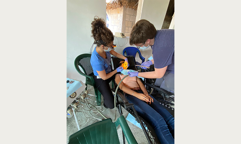 Doctor Chadbourne and dental assistant treating a young girl