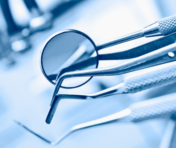 Several dental mirrors and other instruments on table