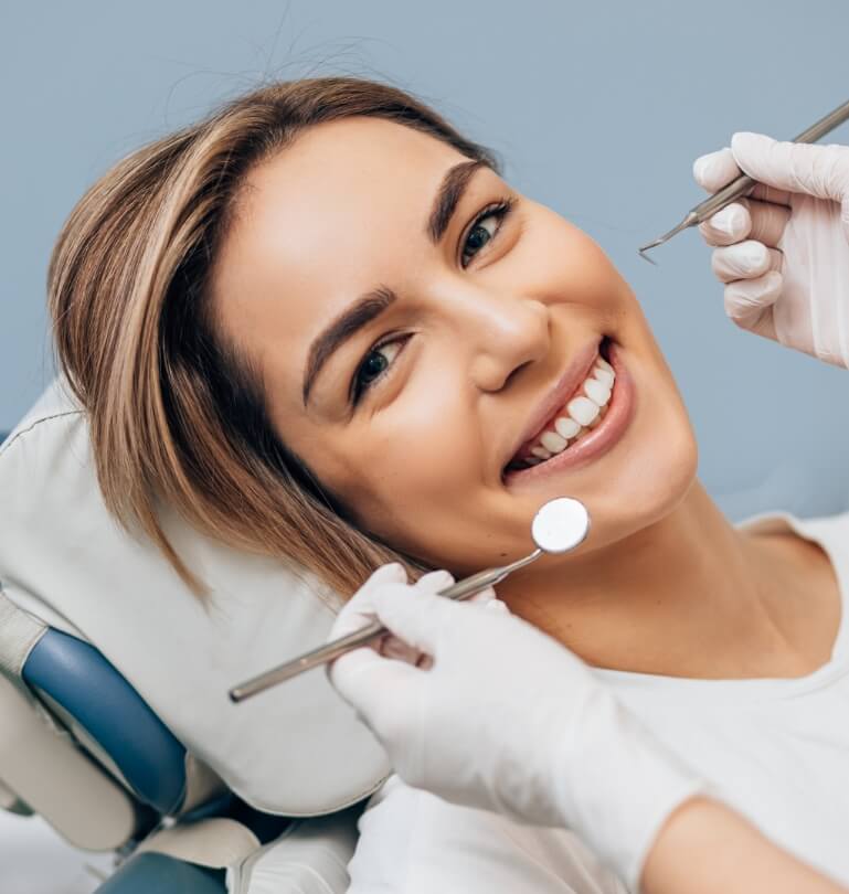 Woman smiling after getting dental implants in Falmouth