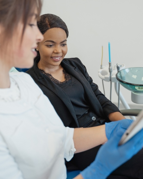 Dentist showing a tablet to a patient