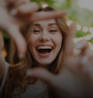 Smiling woman making a square frame shape with her fingers