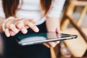 Person typing on a tablet