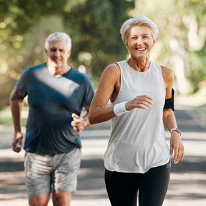 Couple smiling while running outside