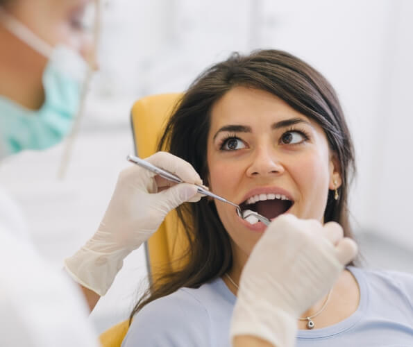 Dentist giving a patient an oral cancer screening