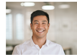 Man in white dress shirt grinning