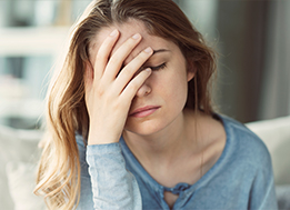 Frustrated woman with her head in her hand