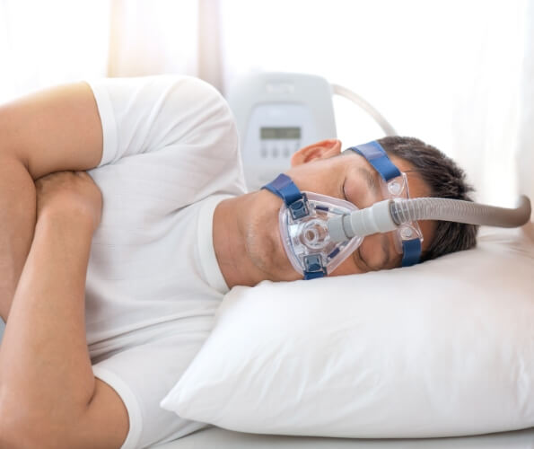 Sleeping man with a C P A P mask over his face